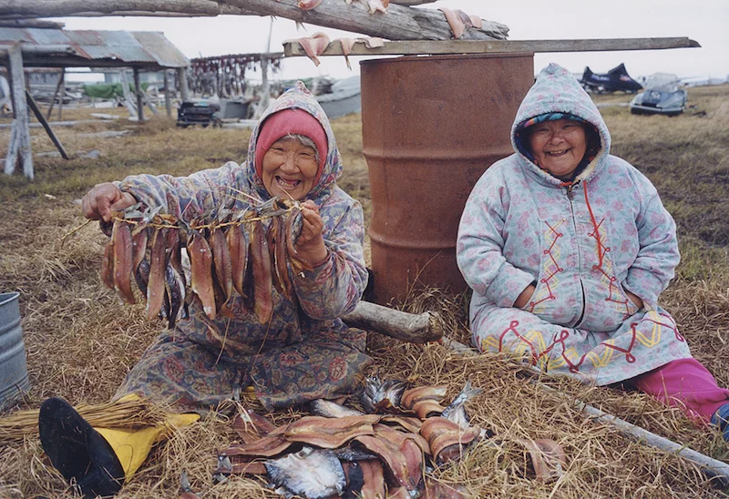 cup'ig ladies with what appears to be fish